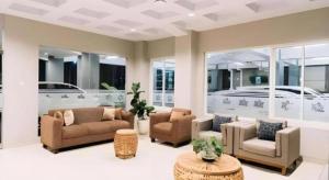 a living room with two couches and a table at HOTEL GRAND KUTILANG SYARIAH in Lampung