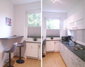 a kitchen with white cabinets and a counter top at GUWO Gästewohnung Friedrich-Schiller-Str 28 in Sprucke