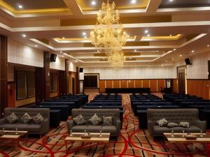 a large room with rows of chairs and a chandelier at Hotel Grand Permata Hati in Geutieue +93 photos
