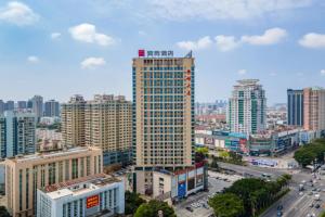 a view of a city with tall buildings at Echarm Hotel Beihai Railway Station in Dianbailiao