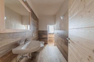 a bathroom with a sink and a mirror at Casa Scola in Falcade +12 photos