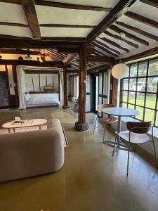 a living room with a couch and a table and a bed at 임진고택, 마차글램핑 Imjingotaek Hanok Stay Jeju Traditional House LP Cozy House, Wagon stay in Jeju