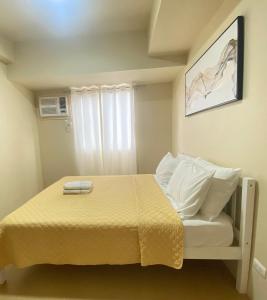 a small bedroom with a bed and a window at Corner 1 Bedroom Unit at Centrio Tower in Cagayan de Oro +8 photos