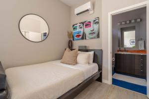 a bedroom with a bed and a mirror and a sink at Stay Portland - Sleek Studio - Food Cart Row & Vintage Shops in Portland