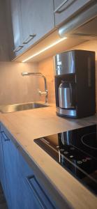 a kitchen with a sink and a microwave at Apartment Hausberger in Mayrhofen