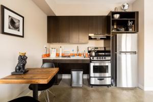 a kitchen with stainless steel appliances and a wooden table at Stay Portland - Bright Studio Apartment - Food Carts & Local Shops in Portland