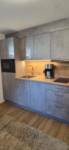 a kitchen with a sink and a counter top at Apartment Hausberger in Mayrhofen +43 photos