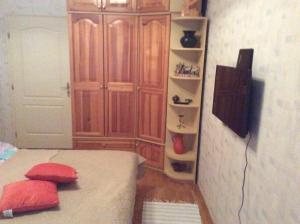 a bedroom with a bed with red pillows on it at Szundi Szob&aacute;k in P&eacute;cs