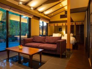 a living room with a couch and a bed at Tsukiyominoza in Ise +190 photos