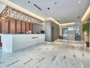 a lobby of a hotel with a reception desk at Magnotel Business Shanghai Minhang Wujing East China Normal University in Shanghai