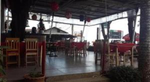 a restaurant with chairs and tables and a bar at Jinta Hotel Nathon Beach in Nathon
