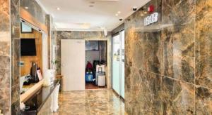 a room with a hallway with a stone wall at Jeju Maple Hotel in Jeju +192 photos
