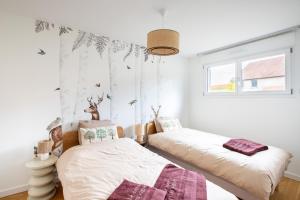 Postel nebo postele na pokoji v ubytování Rodern - Le Cocon des vignes