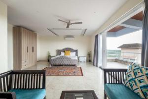 a bedroom with a bed and a large window at Villa Avanora by DanCenter in Arpora +2 photos