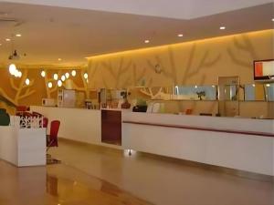 a lobby of a restaurant with a reception counter at 7 Days Inn Zhenjiang Jiangsu University in Tan-t'u-chen