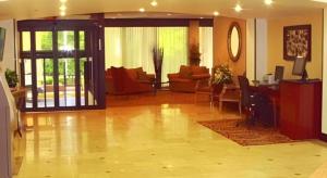 a room with a living room with a table and chairs at Garden Plaza Hotel in Passaic Junction +37 photos