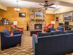 a living room with couches and a stone fireplace at Sleep Inn Bessemer Helena in Bessemer