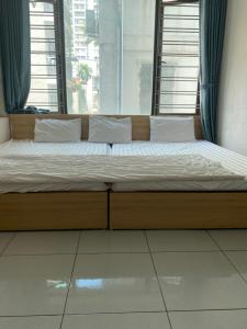 a large bed in a room with a window at nhà trọ my anh in Hanoi