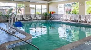 a swimming pool with chairs in a hotel at Quality Inn & Suites Ann Arbor Hwy 23 in Ann Arbor
