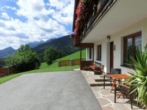 a patio of a house with a table and chairs at Ferienhaus Schwab in Aich +49 photos