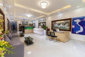 a lobby with a person sitting at a desk in a room at Luxury Airport Hotel & Spa in Phu Lo Dong