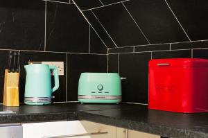 a kitchen counter with two toasters and a red box at 3-Bedroom 5-Bed Flat King Room Free Parking Near Reading & M4 Work Stays in Shinfield +17 photos