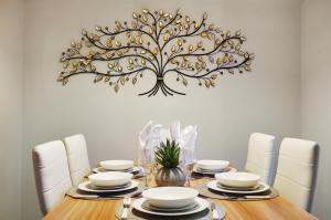 a dining room with a table with a tree on the wall at 3-Bedroom 5-Bed Flat King Room Free Parking Near Reading & M4 Work Stays in Shinfield