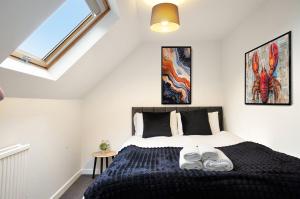 a bedroom with a bed with two pairs of shoes on it at 3-Bedroom 5-Bed Flat King Room Free Parking Near Reading & M4 Work Stays in Shinfield