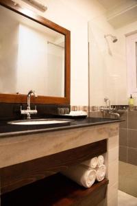 a bathroom with a sink and a mirror and towels at Lemon Tree Hotel Thimphu in Thimphu