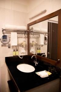 a bathroom with a sink and a mirror at Lemon Tree Hotel Thimphu in Thimphu +11 photos