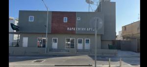 a building with a sign on the side of it at Napa Entry apartments in Ayia Napa