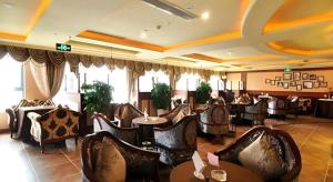 a restaurant with a bunch of chairs and tables at Chengdu French Theme Gold Palace in Chengdu