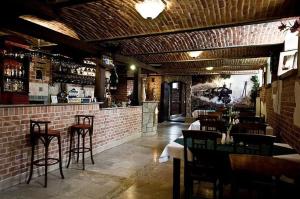 a restaurant with a bar with tables and chairs at Hotel Restauracja Pod Parowozem in Ostrowiec Świętokrzyski