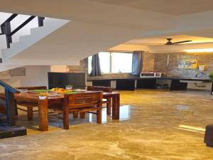 a living room with a table and a kitchen at Ventara Bliss Bungalow by Palette Homes ? 4 BHK | Pvt Pool | Lonavala in Kārli