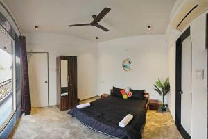 a bedroom with a bed and a ceiling fan at Ventara Escape Bungalow by Palette Homes ? 4 BHK | Pvt Pool | Lonavala in Kārli