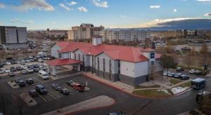 an aerial view of a parking lot with a building at AmericInn by Wyndham Denver Airport in Denver