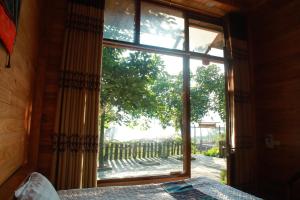 a bedroom with a window looking out at a yard at Mi Su homestay in Sa Pa +14 photos