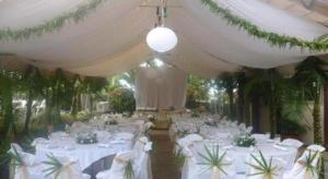 a banquet hall with white tables and white chairs at Le Manumea Hotel in Tiavi