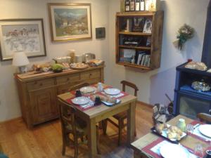 a kitchen with a table and chairs and a table and a tableablish at La Niche B&B in La Thuile
