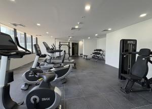 a gym with treadmills and exercise bikes in it at Vista Grande Luxury 3br In Reem By Ayla in Abu Dhabi