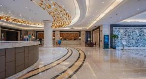a large lobby with a large chandelier in a building at Hangzhou Huachen Fengting Hotel in Hangzhou +234 photos