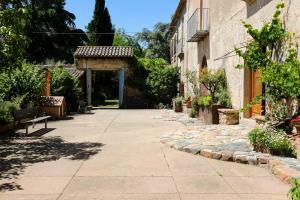 an alley with a stone walkway between two buildings at Can Guilla Gaudeix in Corro d'Amunt