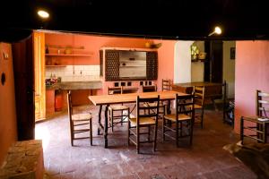 a dining room with a wooden table and chairs at Can Guilla Gaudeix in Corro d'Amunt