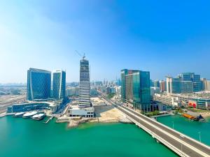 a view of a city with a river and buildings at Vista Grande Luxury 3br In Reem By Ayla in Abu Dhabi