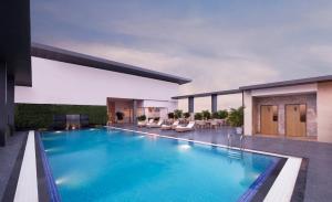 a swimming pool in the middle of a building at Crowne Plaza Lucknow by IHG in Lucknow
