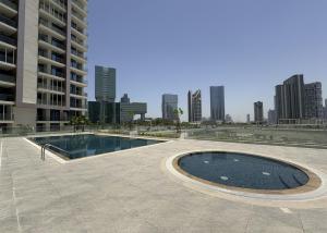 a swimming pool in the middle of a building at Vista Grande Luxury 3br In Reem By Ayla in Abu Dhabi