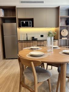 a kitchen with a wooden table with chairs and a refrigerator at Margot Apartments By MrW in Guadalajara +273 photos