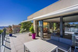 a patio with a bench and a table on a house at SUPERBE VILLA VUE MER JUSQU'A 14 COUCHAGES La LONDE LES MAURES Entre HYERES et Le LAVANDOU 4 Etoiles PISCINE CHAUFFEE in La Londe-les-Maures