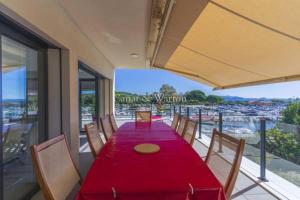 a dining room with a red table and chairs at SUPERBE VILLA VUE MER JUSQU'A 14 COUCHAGES La LONDE LES MAURES Entre HYERES et Le LAVANDOU 4 Etoiles PISCINE CHAUFFEE in La Londe-les-Maures