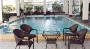 a large swimming pool with chairs and a table in a hotel at Huu Nghi Hotel in Hai Phong